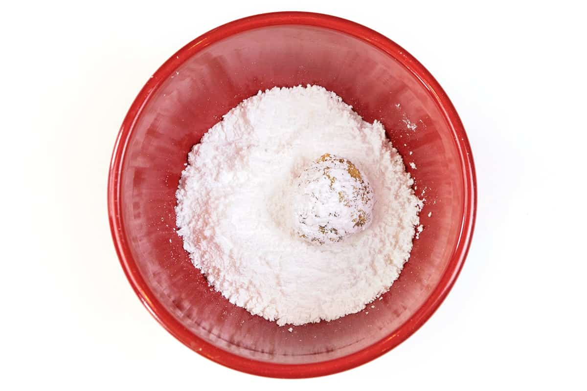Roll the orange ball in the powdered sugar.