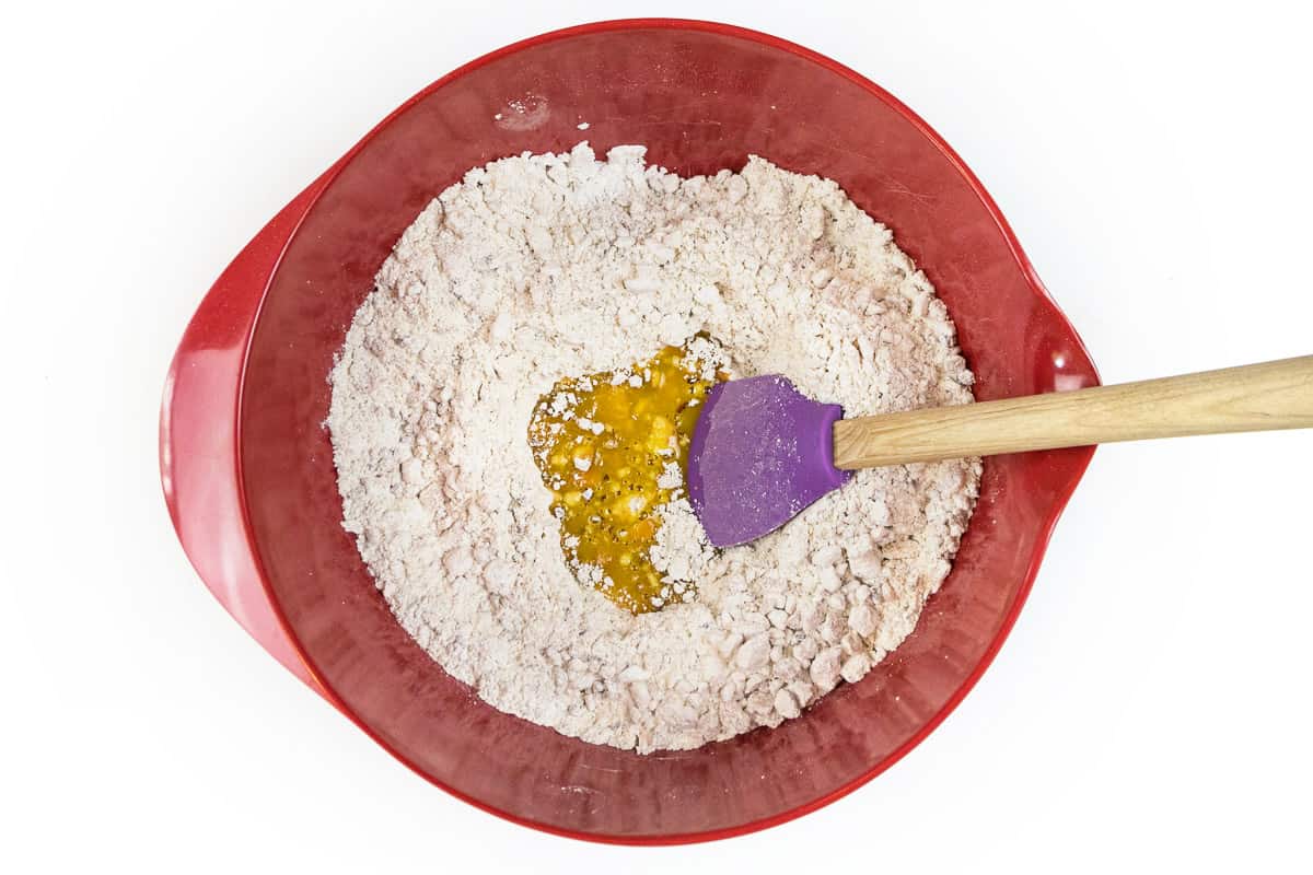 Add the orange juice concentrate to the mixed pecans, powdered sugar, and vanilla wafers.
