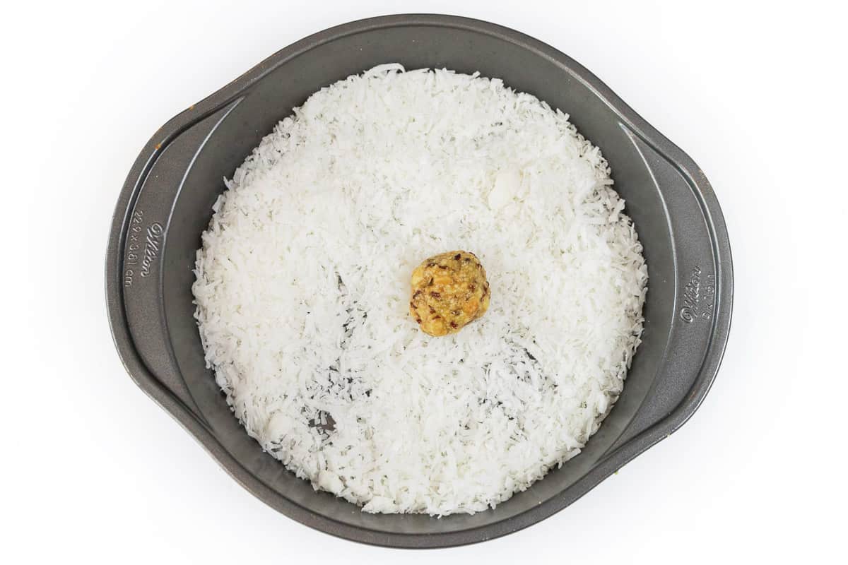 Put an orange ball into the coconut.