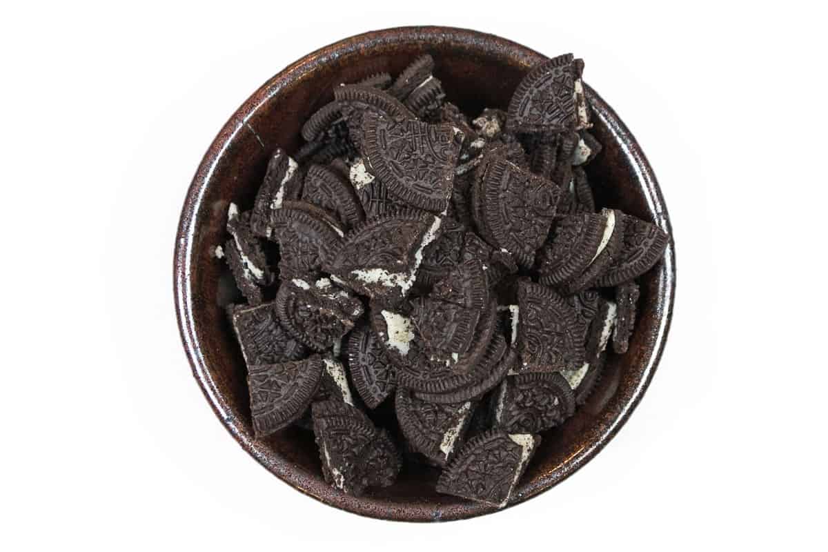 Thirty-five Oreo cookies are broken into pieces.
