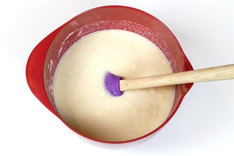 The Bisquick is mixed with the sugar, butter, and milk in a bowl.