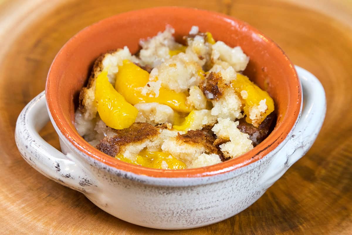 Peach cobbler with Bisquick in a bowl.