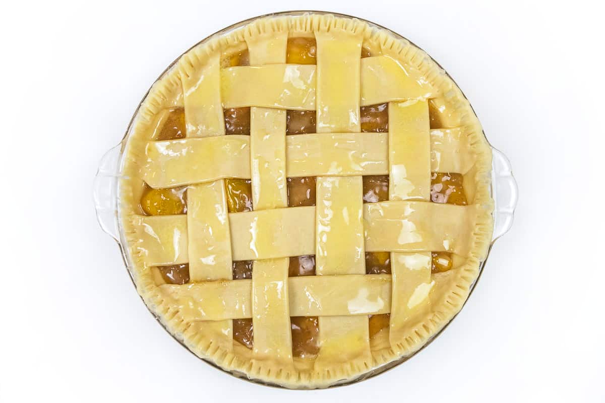 Put the peach pie into the oven.