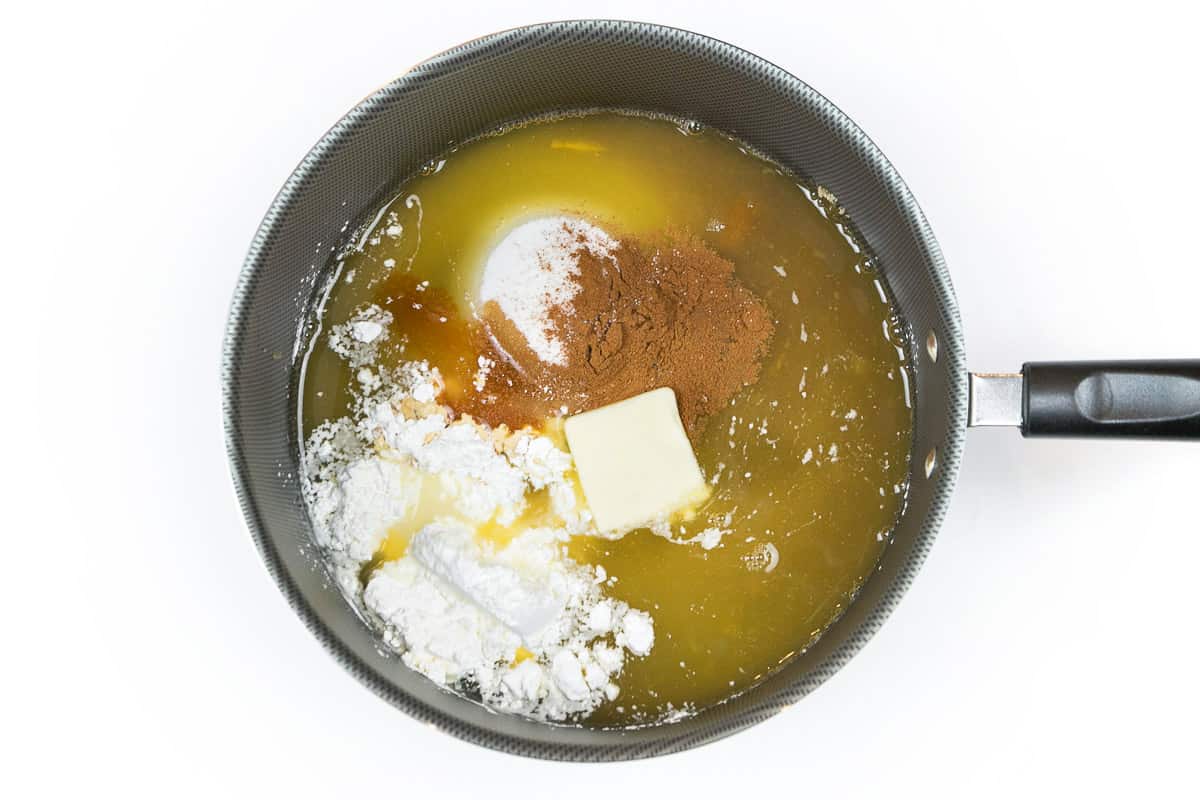 Add the granulated sugar, brown sugar, cornstarch, lemon juice, vanilla extract, table salt, ground cinnamon, and butter to the peach juice.