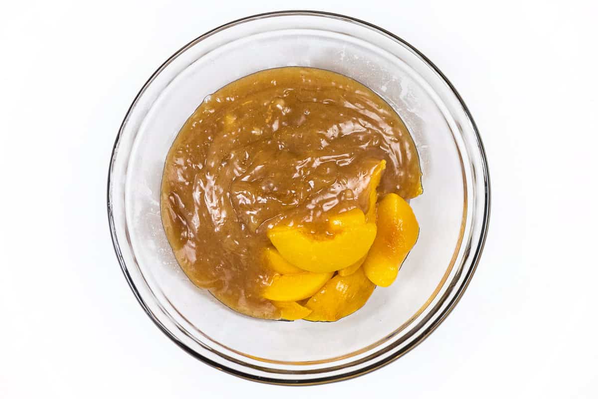 Add the thickened peach juice to the peaches.