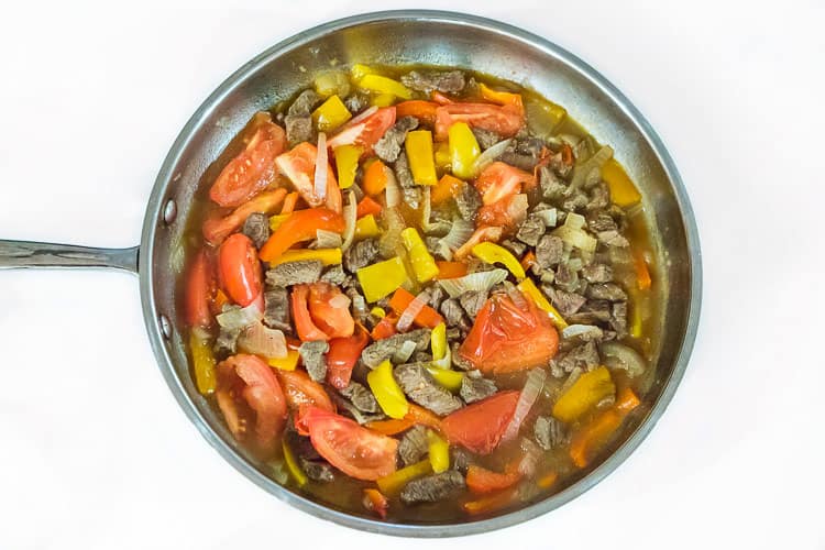 Pepper steak with onions and tomatoes.