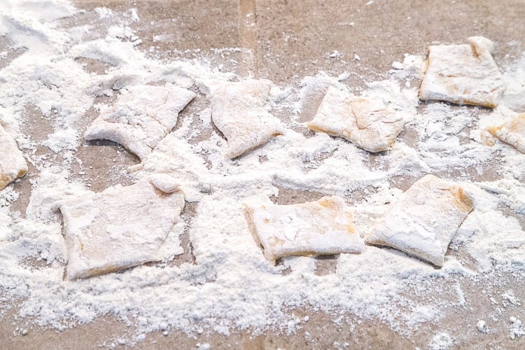 Pierogi dough cut into squares.