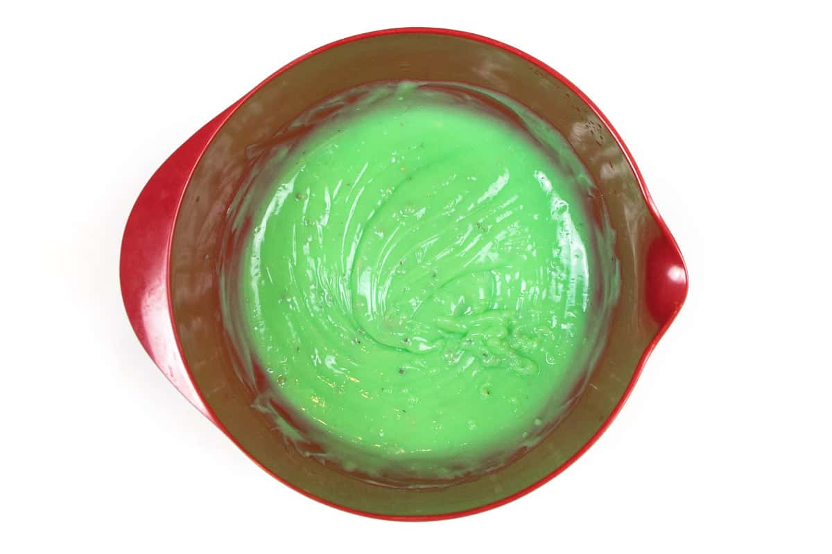 The instant pistachio pudding and cold milk are stirred until thickened.