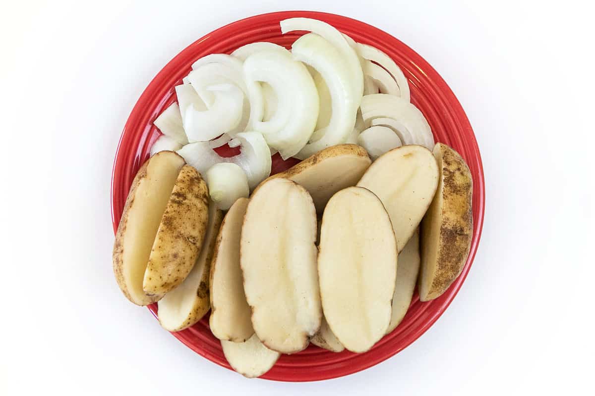 Cut up onions and potatoes.