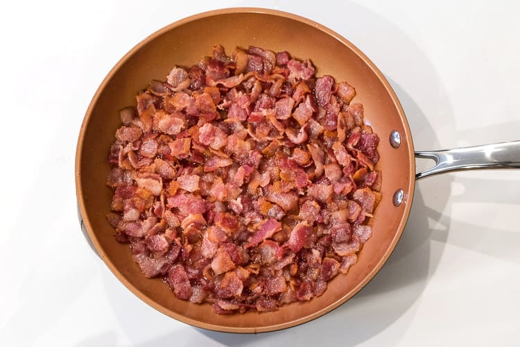 Bacon frying in a skillet.