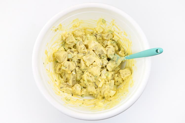 Mix potatoes with the hard-boiled eggs, celery, chopped onion, sweet relish, salt, pepper, mayonnaise, and yellow mustard in the bowl.