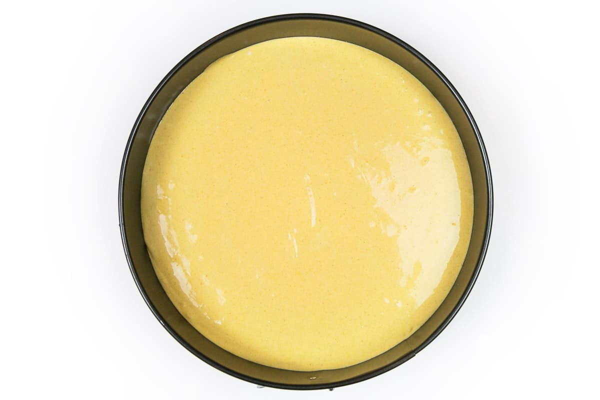 The pumpkin cheesecake batter is poured on top of the graham cracker crust.