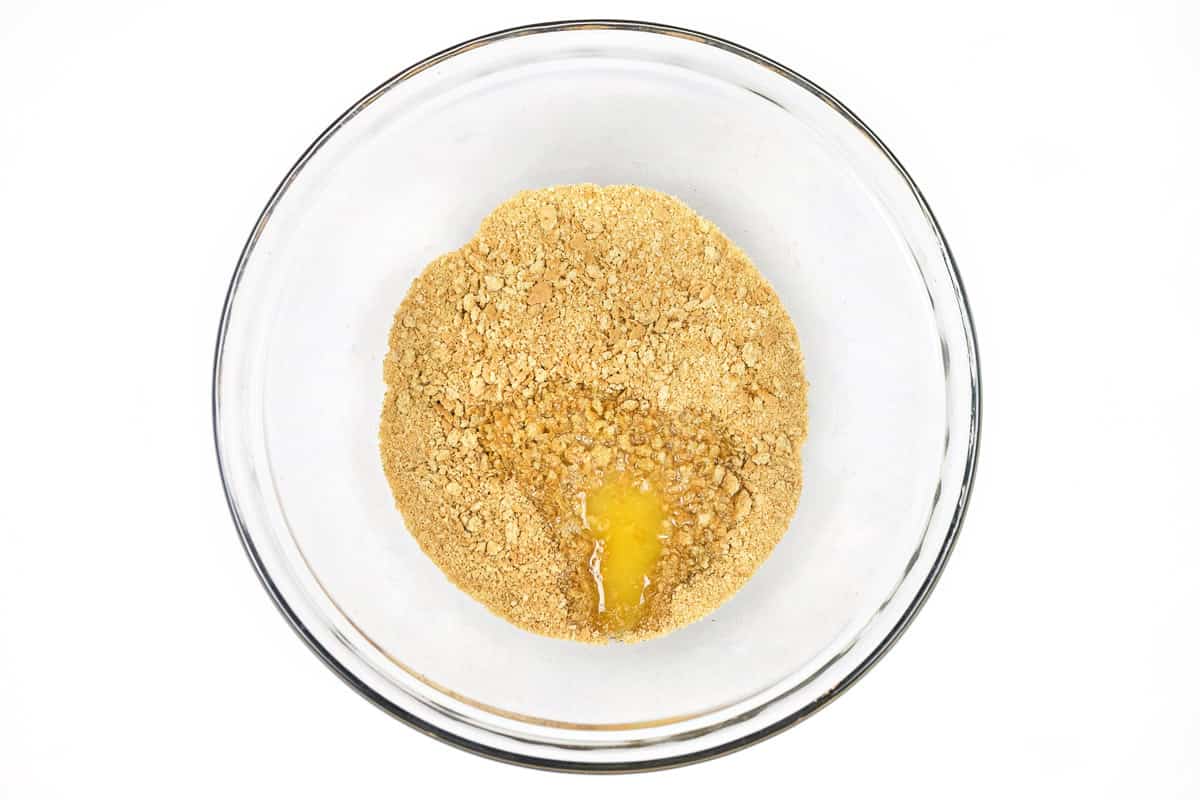 Add the melted butter to the graham cracker crumbs.