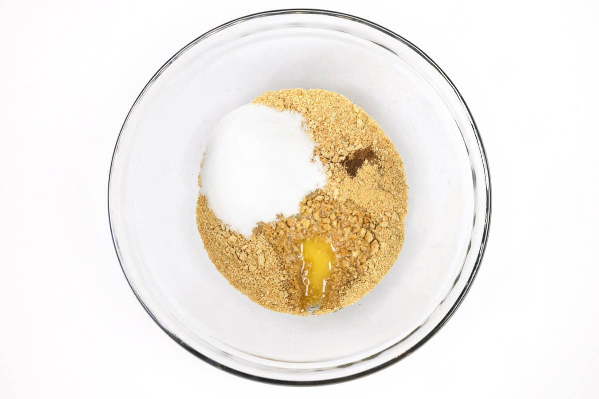 The sugar, cinnamon, cloves, and ginger were added to the melted butter and graham cracker crumbs.