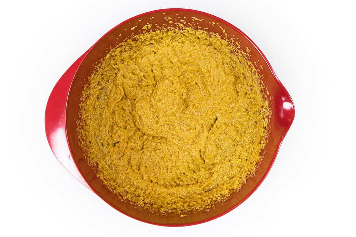The butter and sugar mixture, eggs, pure pumpkin puree, and vanilla extract are blended well.