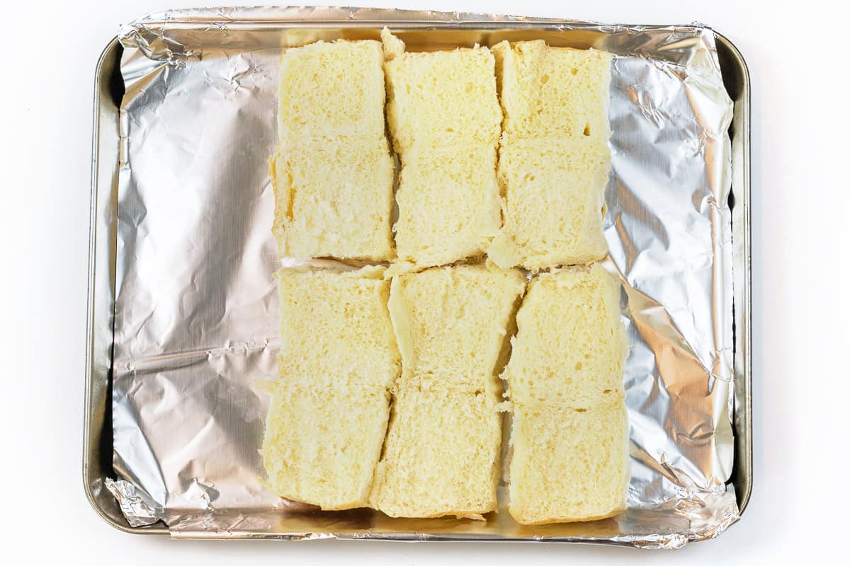 The bottom part of the Hawaiian rolls is cut in half.