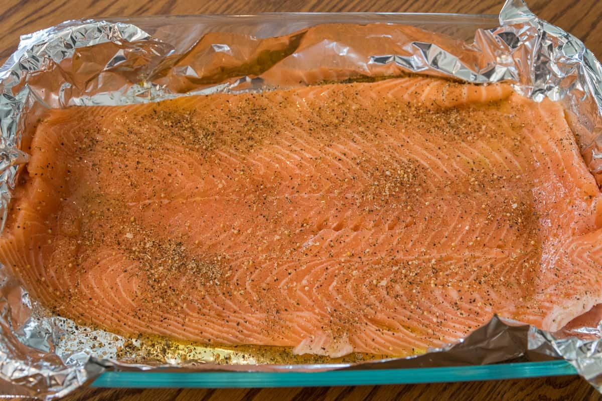 Raw salmon is ready to go into the oven at three hundred and fifty degrees for forty-five minutes.