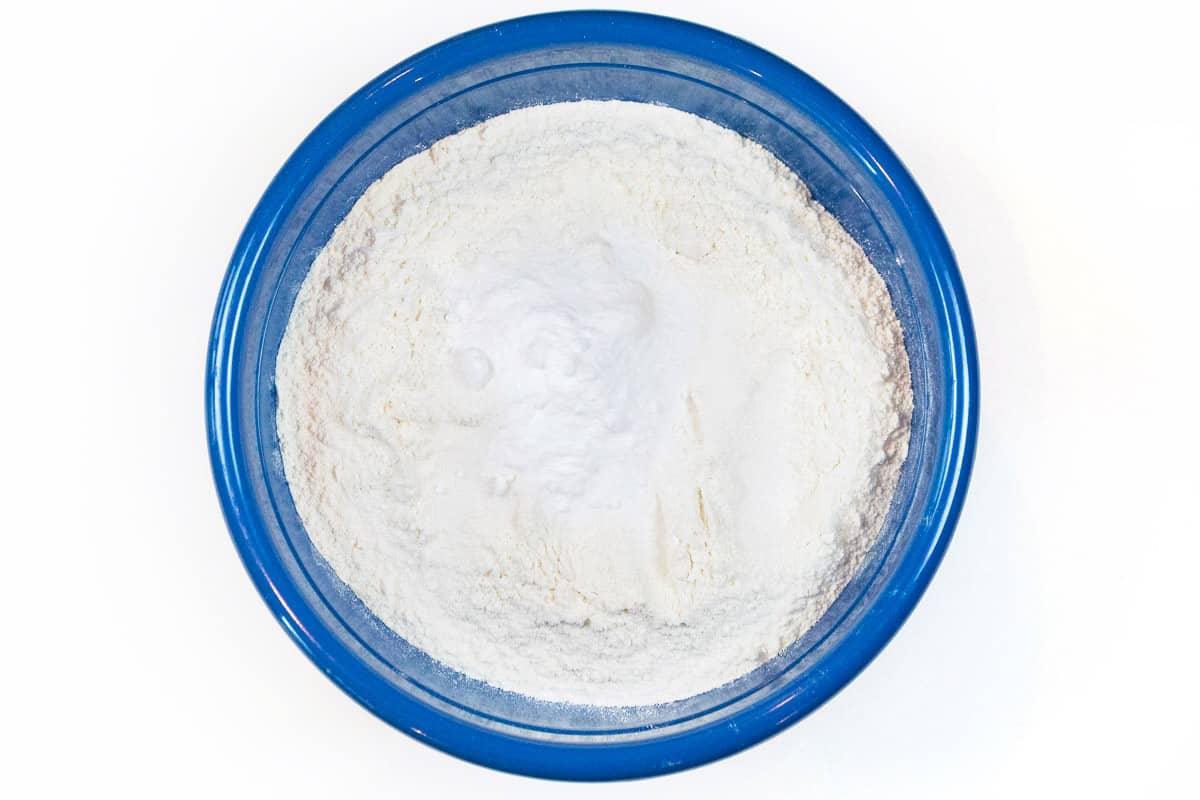 In a medium-sized bowl, add four and one half cups of flour, two teaspoons of salt, and two teaspoons of baking soda. Mix until blended.