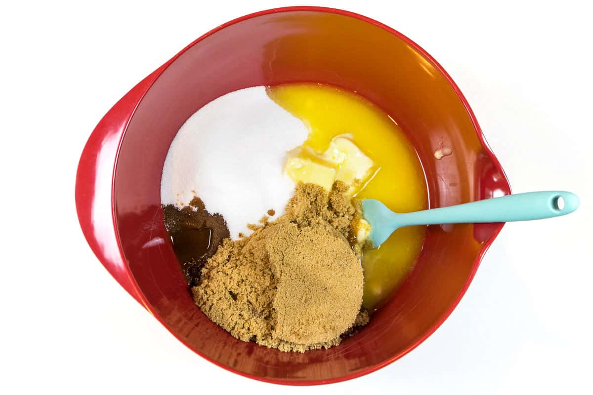 Put the melted butter, one and a half cups of granulated sugar, one and a half cups of brown sugar, and two teaspoons of vanilla extract in a bowl.