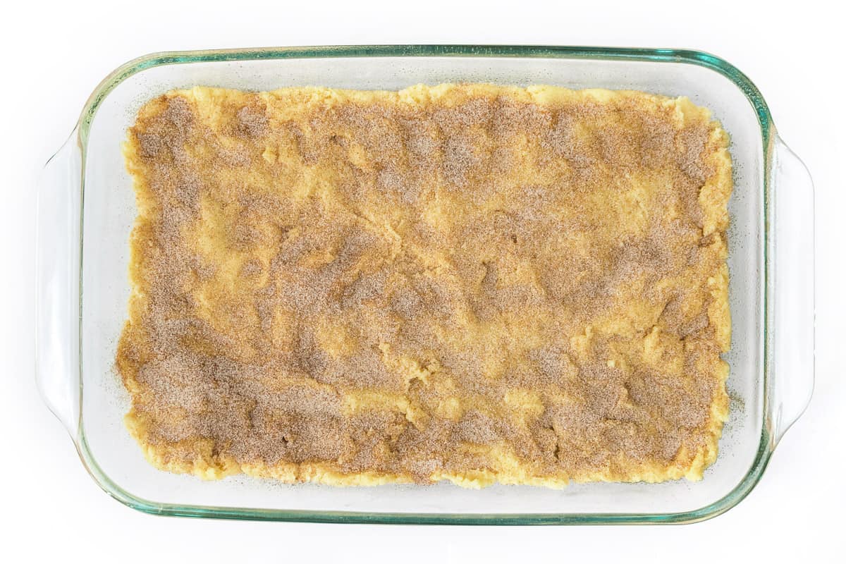 Sprinkle the sugar and cinnamon on top of the cookie dough.
