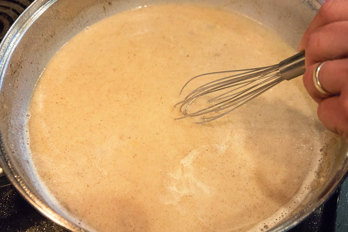 Add one-fourth teaspoon of table salt, one-fourth teaspoon of black pepper, one-eight teaspoon of cayenne pepper, and one-eight teaspoon of garlic powder and any other seasonings you like. Continue to stir and to cook over medium heat until desired thickness. Our gravy took about ten minutes to thicken.