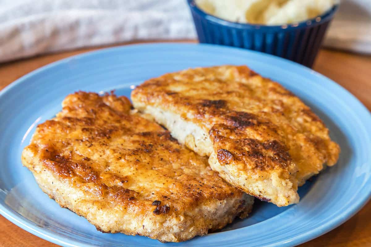 Fried pork chops recipe on a plate.
