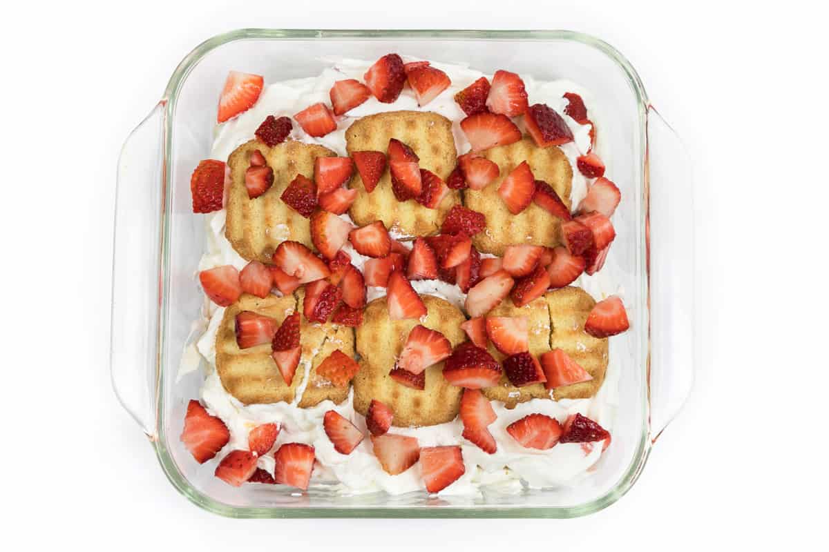 The sixth layer of the cake is another one-third of the strawberries.