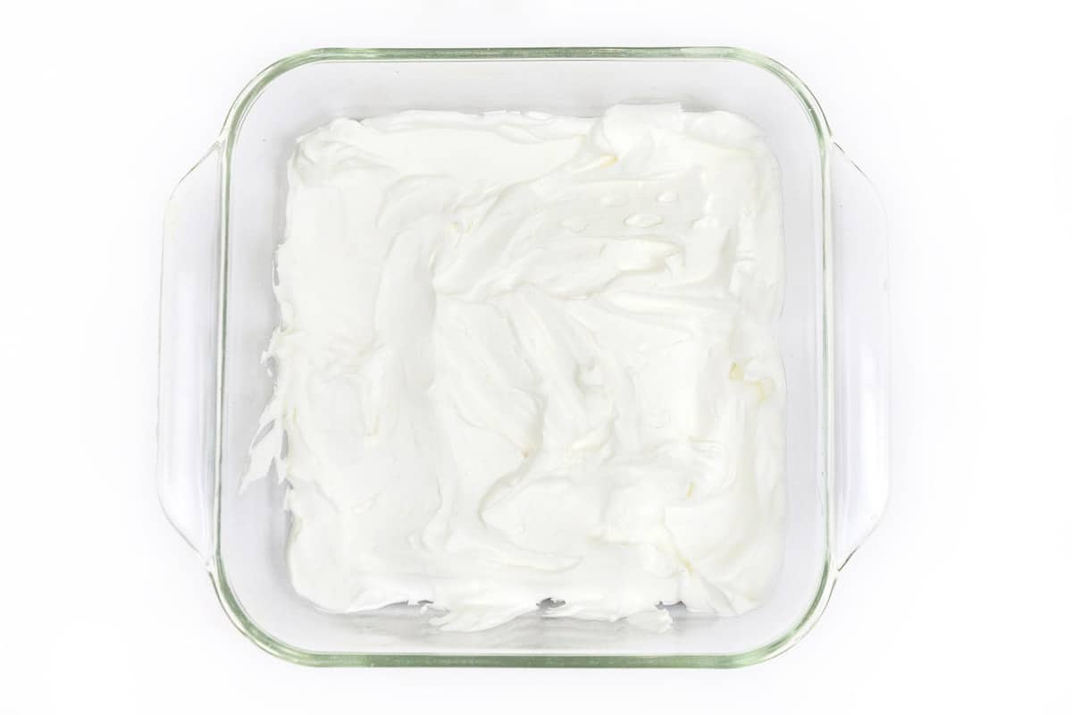 The first layer of the cake is whipped cream.