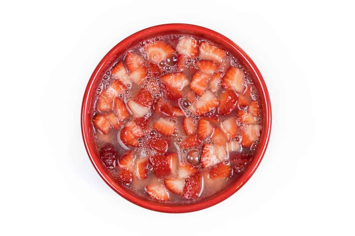 Strawberries and lemon juice in a bowl.
