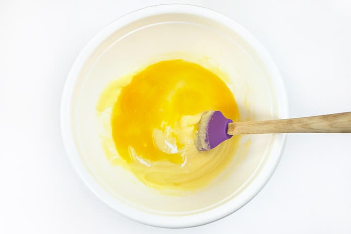 Two eggs are added to the bowl with the butter and the sugar.
