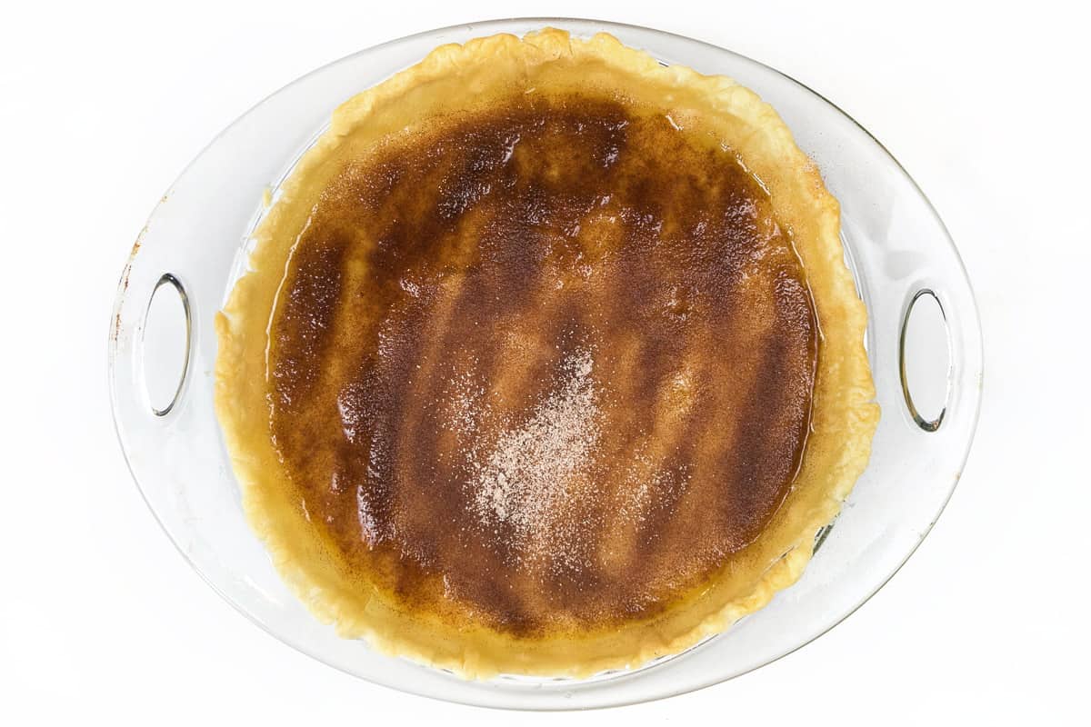 The cinnamon sugar mixture is sprinkled over the melted butter.
