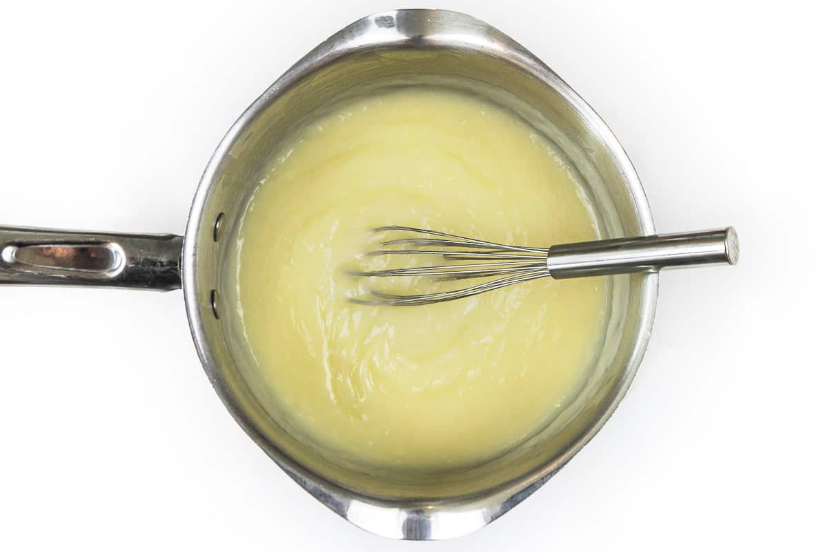 Whipping cream thickens in the saucepan.