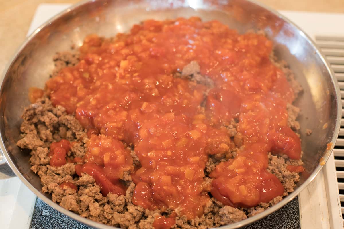 La Victoria Salsa Victoria, ketchup, and cayenne pepper is added to the ground  beef in the frying pan.
