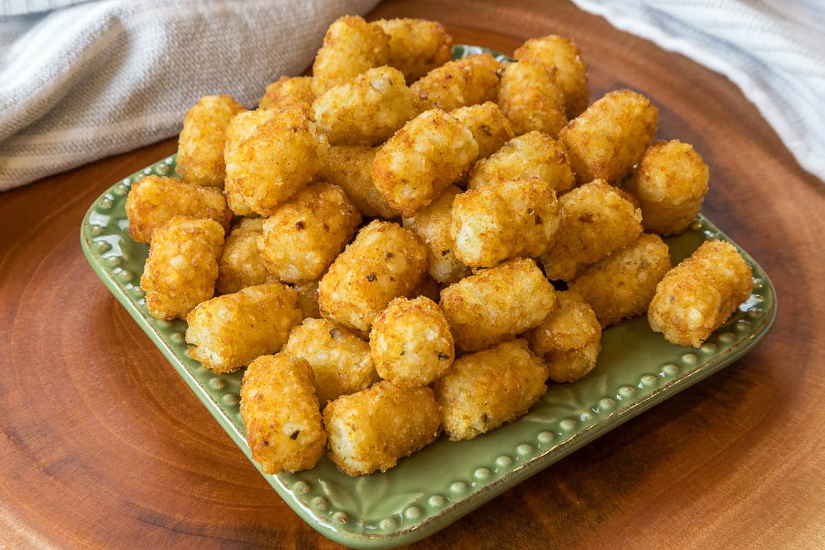 Close-up photo of air fried tater tots on a plate.