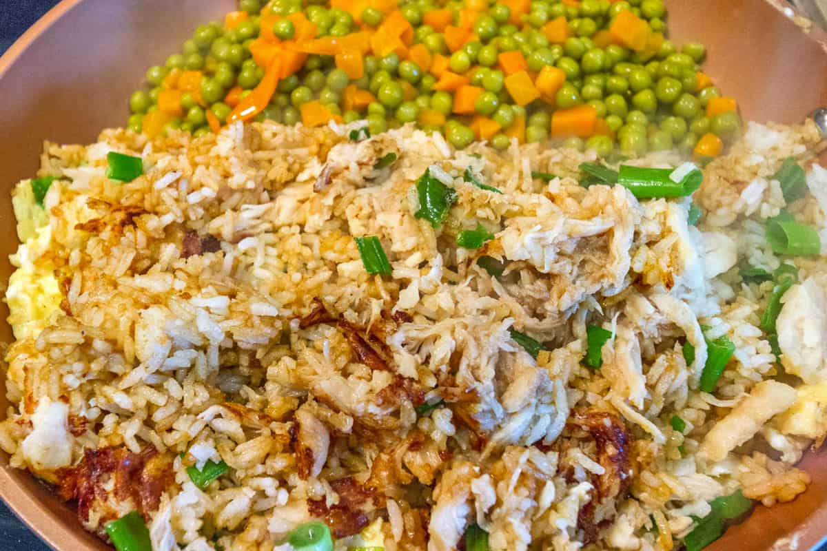 Add the peas and carrots to the frying pan.