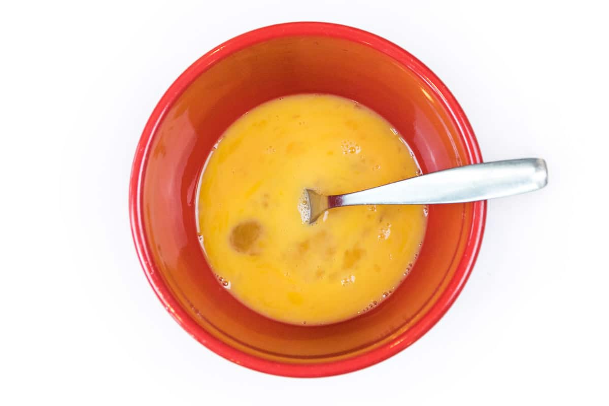 Beaten eggs in a bowl.