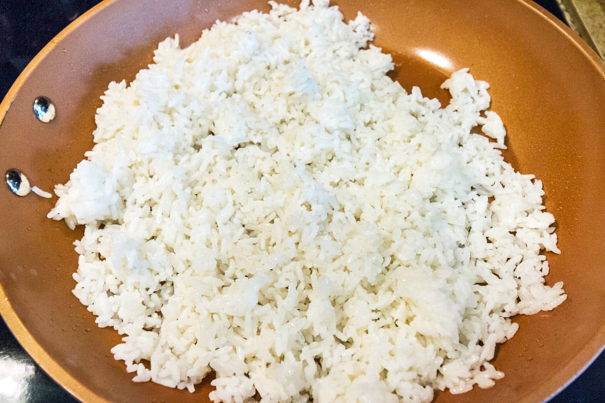 Add the cooked white rice to the frying pan. Fry for two to three minutes on high heat.