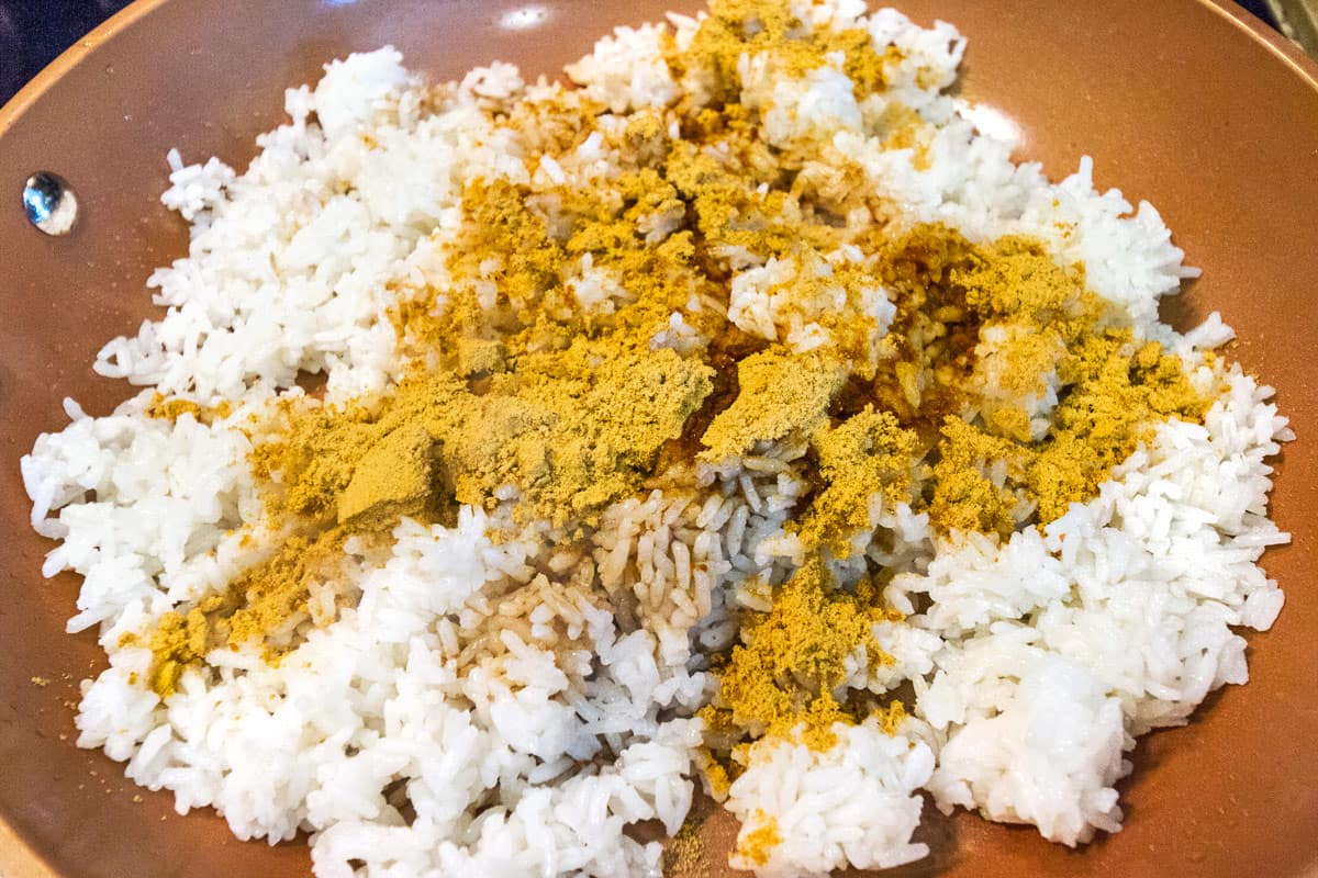 Add seasoning mix and soy sauce to the frying pan and stir together with the rice.