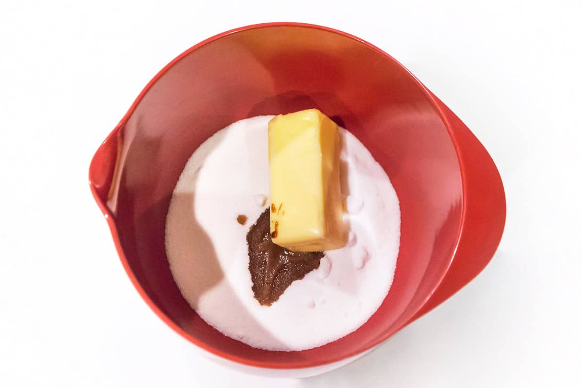 The softened butter, sugar, and vanilla extract are added to a large bowl.