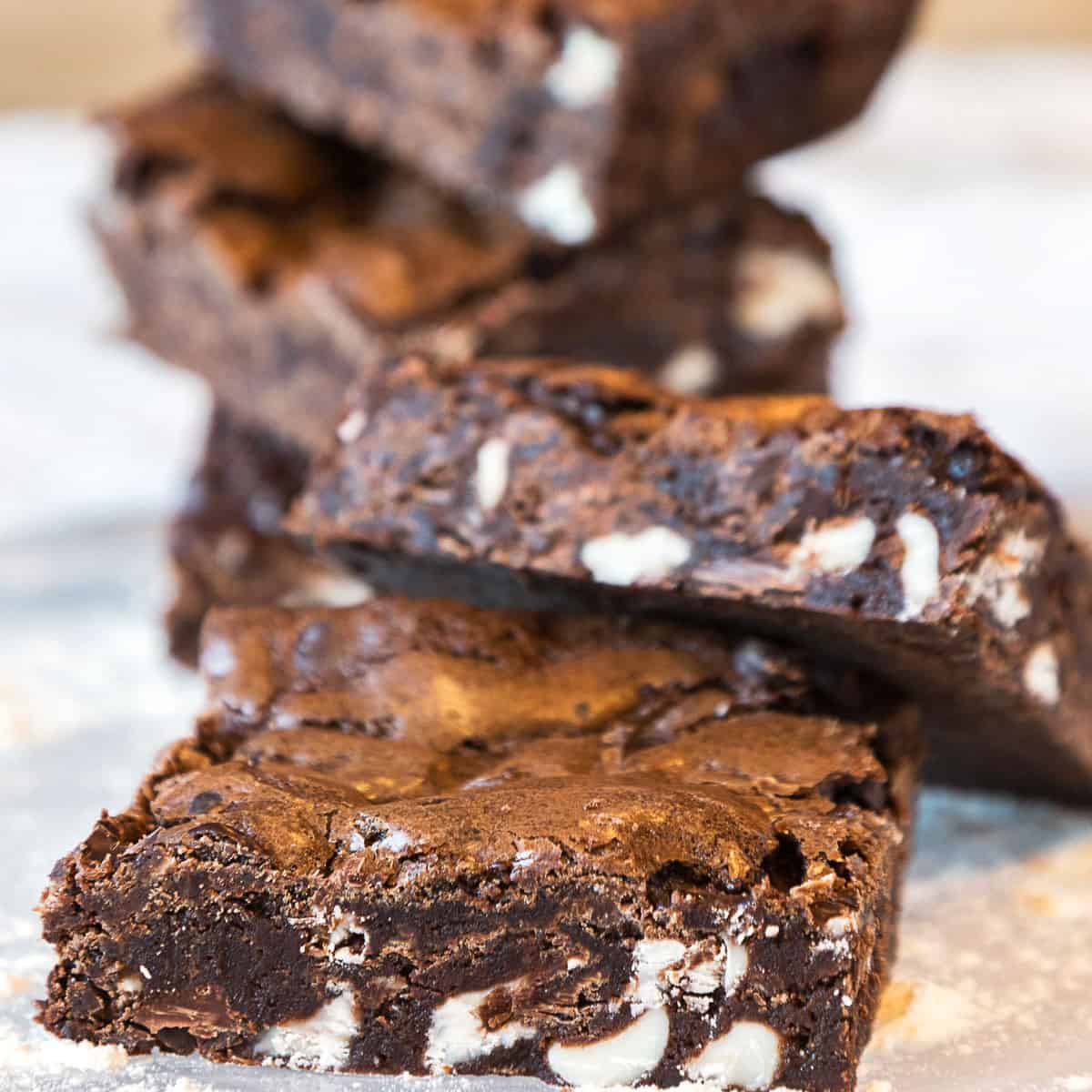 Triple chocolate brownies stacked.