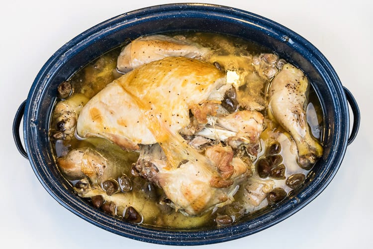 Baked turkey breast and turkey legs in roasting pan.