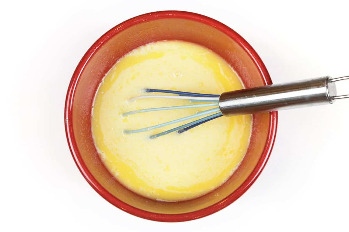 Beat two large eggs, then mix the two beaten eggs with one cup of buttermilk and one-fourth cup of melted butter.