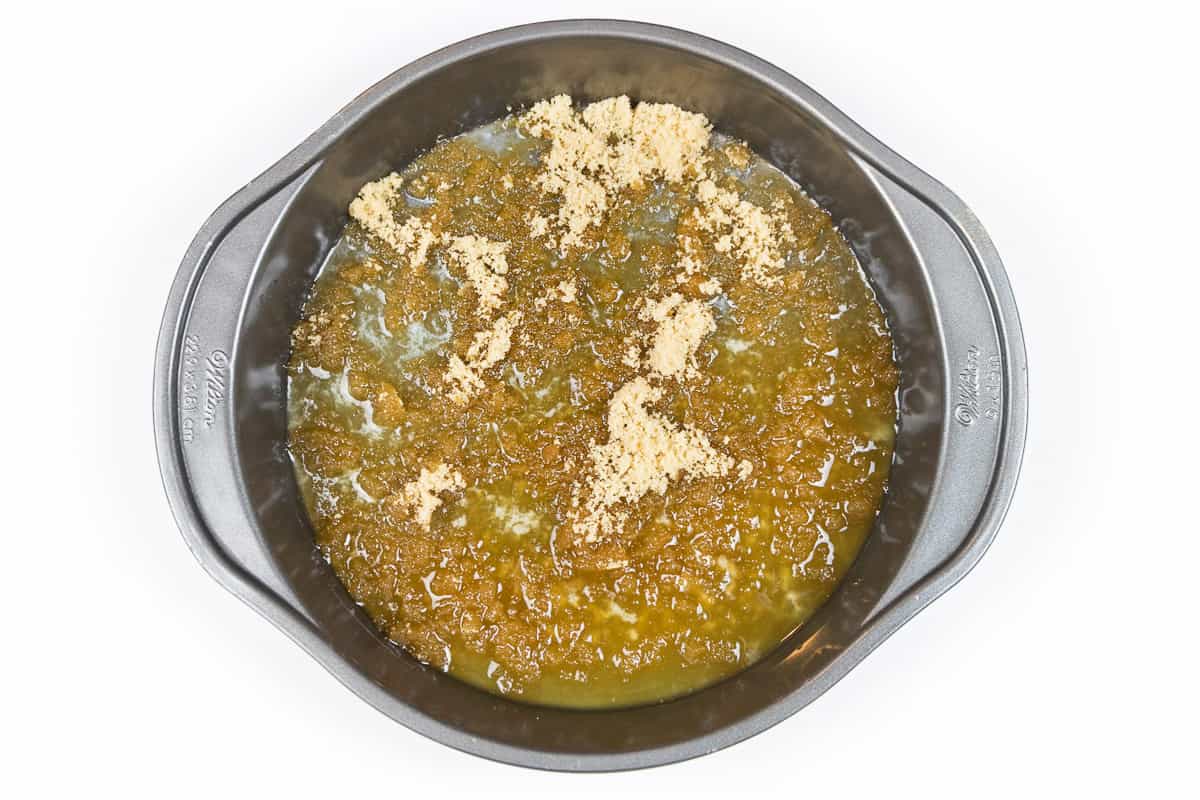 In the nine-inch cake pan, sprinkle one-half cup of brown sugar evenly over the melted butter.